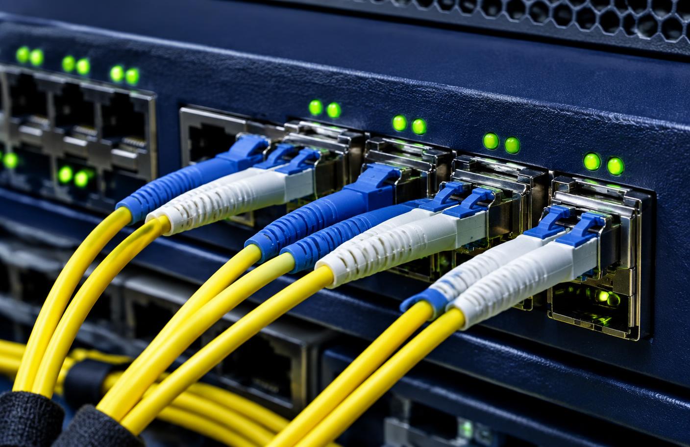 Fibre optic patch cables connected to network switch ports